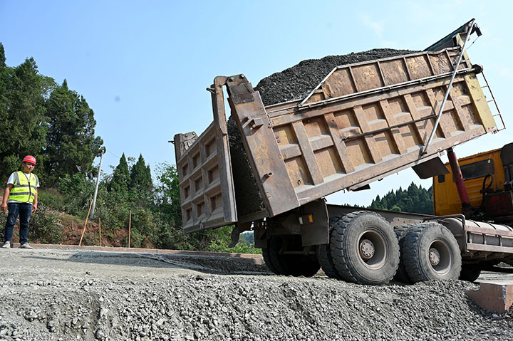 1666765386140104.jpg 1筑路工人正在傾卸鋪路材料.jpg