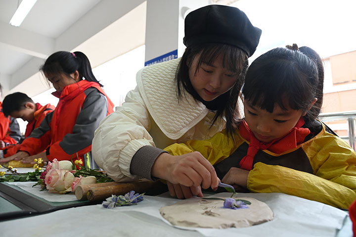 圖3  浮雕興趣班的學生正在老師指導(dǎo)下學習浮雕創(chuàng)作.jpg