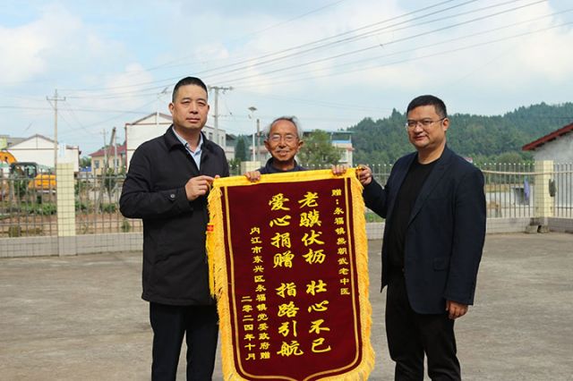 圖3  11月11日，內(nèi)江市東興區(qū)永福鎮(zhèn)黨委書記鄭明超，鎮(zhèn)黨委副書記、鎮(zhèn)長邱剛向該鎮(zhèn)九旬老中醫(yī)熊朝武贈送錦旗。.jpg