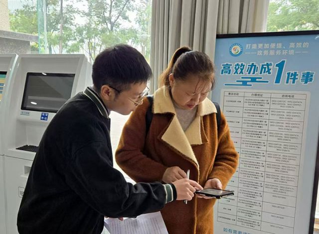 圖1  工作人員指導(dǎo)群眾手機(jī)繳費(fèi).jpg